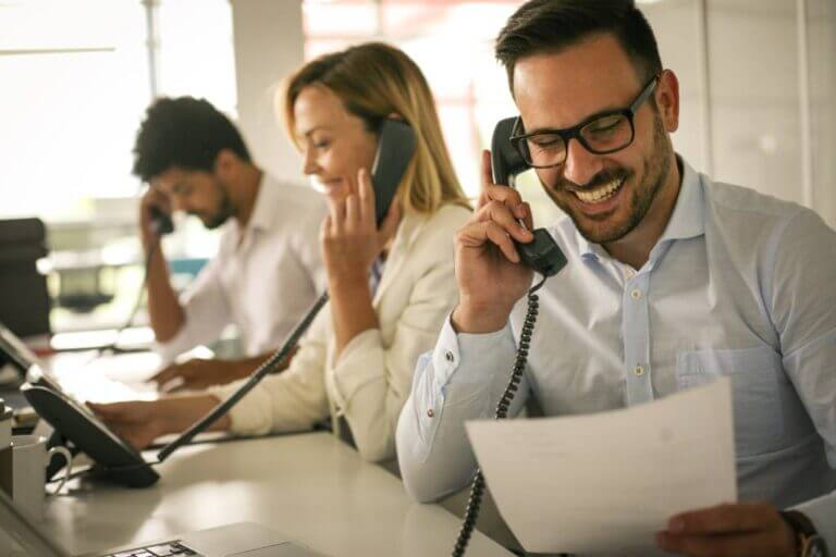 People making sales calls in a office